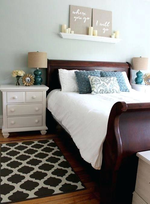 A sleigh bed's footboard scrolls away from the mattress