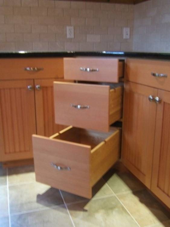 Remodeled kitchen with cabinet drawer for waste and recyclable baskets by Neal's Design Remodel