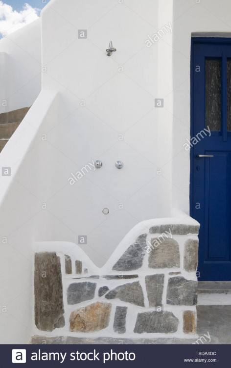 A woman takes an outdoor shower