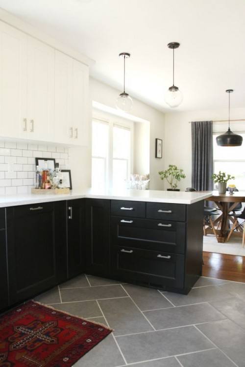 A traditional looking wood look tile is both practical and pretty in this galley kitchen