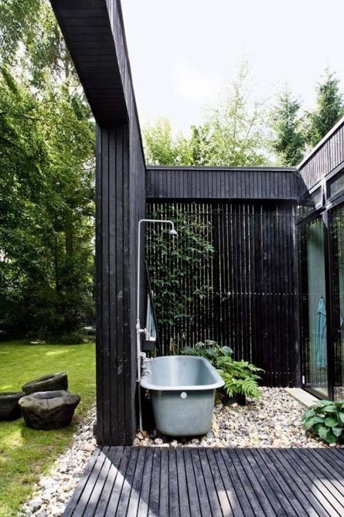 Extend the indoor bathroom outside with a glass wall shower area [Design: Slifer Designs