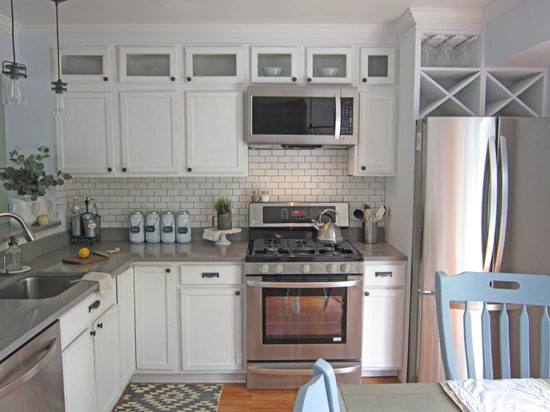 These kitchen the cabinets appear to have added molding and wood to make the shorter cabinets go all the way to the ceiling…