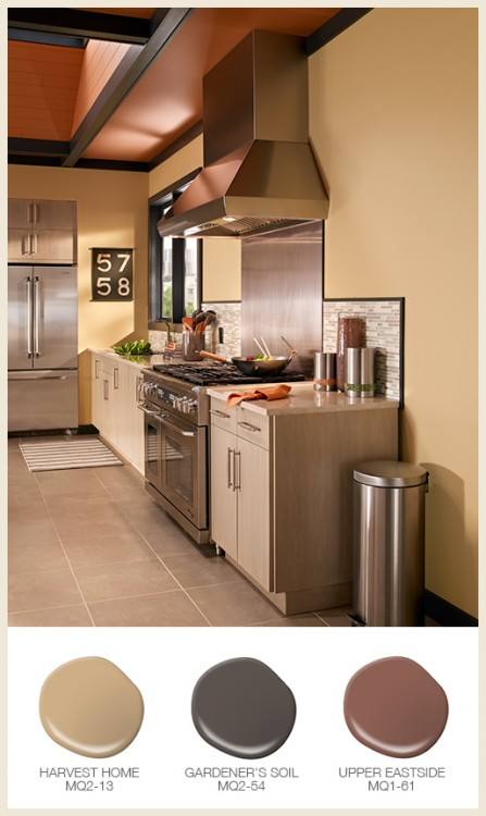 A pop of purple adds subtle color to this gray glass tile backsplash