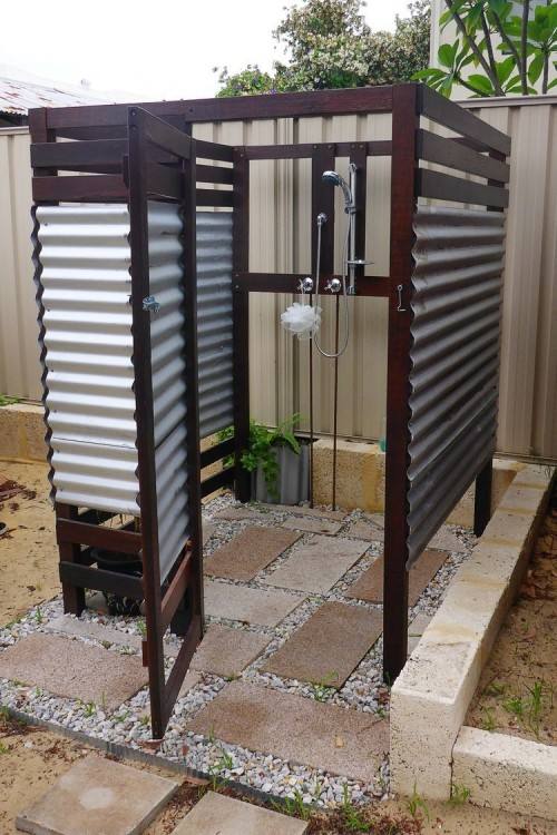 Extend the indoor bathroom outside with a glass wall shower area [Design: Slifer Designs