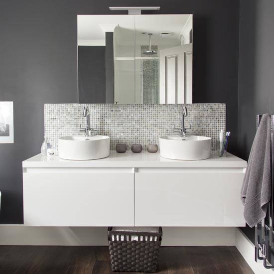 Contemporary bathroom in London with white cabinets, a wall mounted toilet and white walls