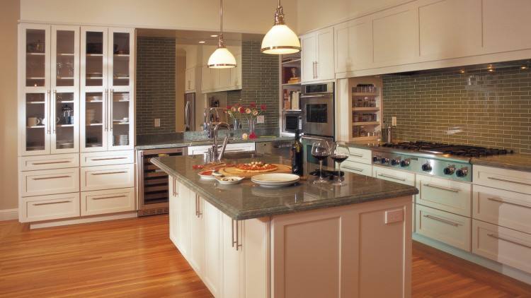 Off white cabinets in casual kitchen by Kitchen Craft Cabinetry