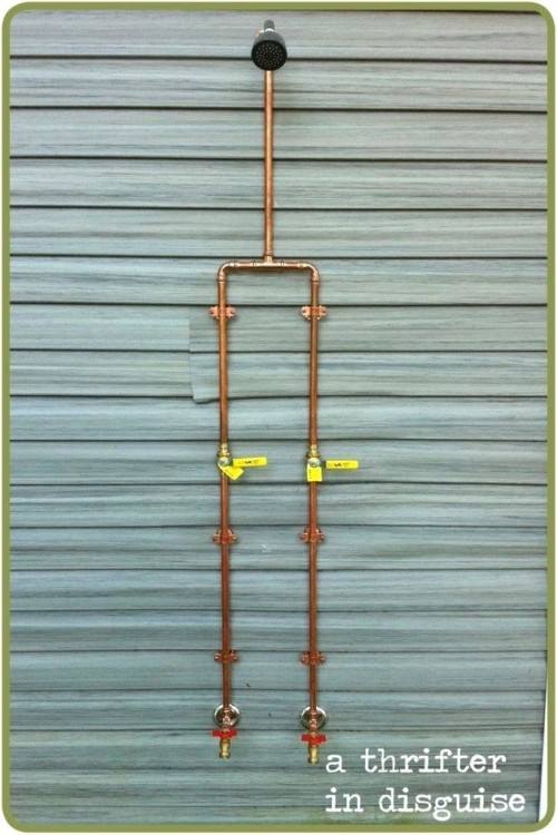 An outdoor shower made from copper pipe and fittings provides a place to rinse off beach sand