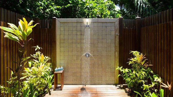 Private outdoor shower with flowers and waterfall at the Palmwood Bed and Breakfast Kilauea Hawaii