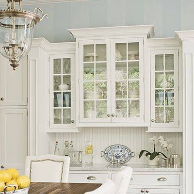 Reeded glass cabinet in the center offers textural contrast in this kitchen space