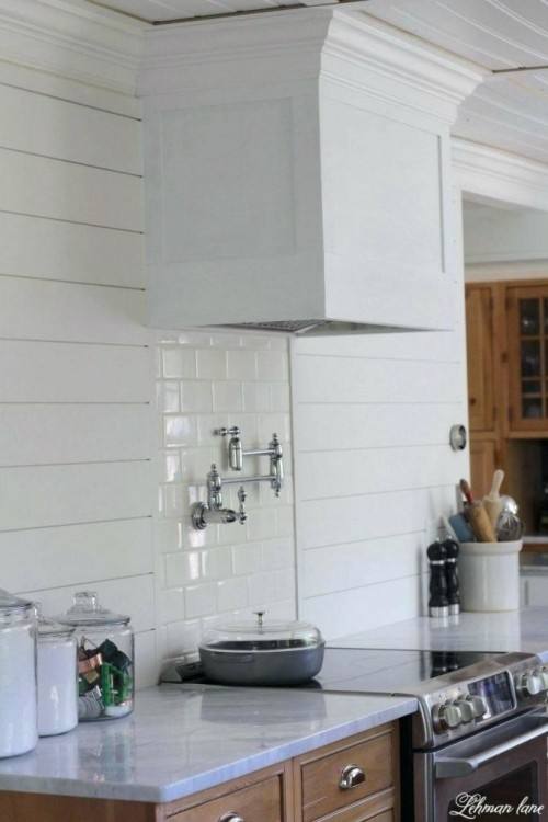 Elegant pot filler faucet in Kitchen Traditional with Water Spigot Above  Stove next to Built In Range Hood alongside Legacy Cabinets and Shaker  Crown