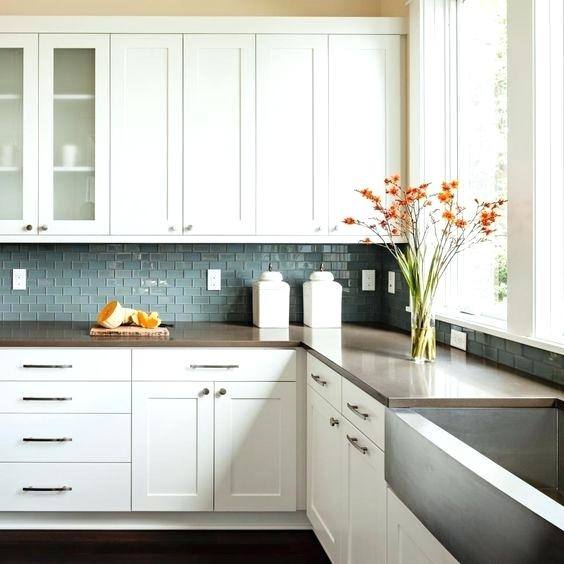 Bright orange painted cabinets and drawers certainly brighten up a white kitchen